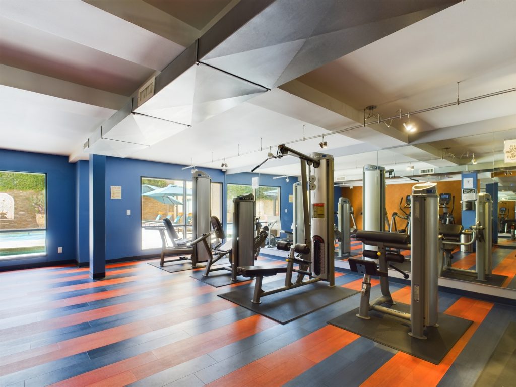 Apartmets in Burbank A gym with blue striped floor and equipment, located in Burbank.